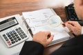 Businessman looking at invoice through magnifying glass Royalty Free Stock Photo