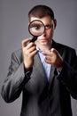 Businessman looking through a magnifying glass Royalty Free Stock Photo