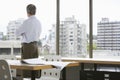 Businessman Looking Through Office Window