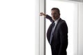 Businessman Looking Out a Big Window Royalty Free Stock Photo