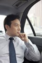 Businessman looking out car window Royalty Free Stock Photo