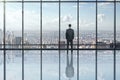 Businessman looking out of window in modern empty office interior Royalty Free Stock Photo