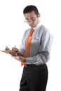 Businessman looking over his glasses with clipboard on hand - fr Royalty Free Stock Photo