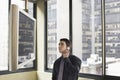 Businessman Looking At Plasma Television While Communicating On Mobile Phone Royalty Free Stock Photo