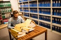 Businessman looking at stack of files on table in storage room Royalty Free Stock Photo