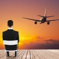 Businessman looking at sunset and airplane Royalty Free Stock Photo