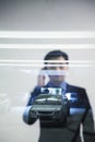 Businessman looking thorough window in parking garage, reflection of car Royalty Free Stock Photo