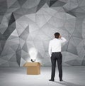 Businessman looking to lightbulb in box Royalty Free Stock Photo