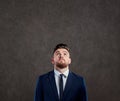 Businessman is looking up at copyspase background. Royalty Free Stock Photo