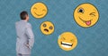 Businessman looking at various emojis