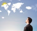 Businessman looking at world clouds and sun Royalty Free Stock Photo