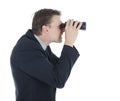 Businessman looking worried through binocular