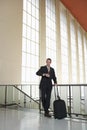 Businessman Looking At Wristwatch At Airport Royalty Free Stock Photo