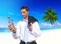 Businessman Looks at Message in a Bottle