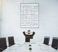 Businessman looks at the poster with equations in modern conference room with oval table