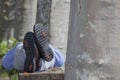 Businessman lying on a bench in a park Royalty Free Stock Photo