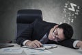 Businessman lying on desk with closed eyes Royalty Free Stock Photo