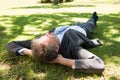 Businessman lying on grass in park Royalty Free Stock Photo