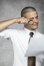 Businessman with magnifying glass reading contract