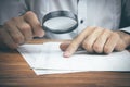 ..Businessman with magnifying glass reading documents Royalty Free Stock Photo