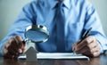 Businessman with magnifying glass reading documents Royalty Free Stock Photo