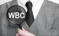 Businessman with magnifying glass on the white background. WBC sign