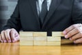 Businessman make a building with wood blocks Royalty Free Stock Photo