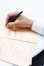 Businessman makes notes at a business seminar. Close up businessman hand holds a pen and writes. businessman doing paperwork. Royalty Free Stock Photo