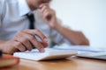 Businessman making calculation with pen in hand, finances concept Royalty Free Stock Photo