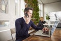 Businessman with making a call and working on laptop while sitting in the office Royalty Free Stock Photo