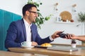 Businessman making contactless card payment in a cafe Royalty Free Stock Photo