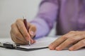 Businessman making notes on the paper in his office