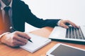 Businessman making notes on the paper at window edge Royalty Free Stock Photo