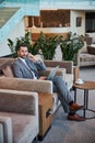 Businessman making a phone call in a waiting room Royalty Free Stock Photo