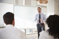 Businessman Making Presentation To Colleagues In Office Royalty Free Stock Photo