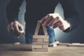 Businessman making a pyramid with empty wooden cubes Royalty Free Stock Photo