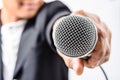 Businessman making speech with microphone and hand gesturing. Royalty Free Stock Photo