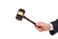 A businessman male hand holds a wooden judge gavel isolated on a white background.