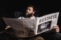 Businessman man reading newspaper while sitting in armchair Royalty Free Stock Photo