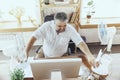 Businessman, manager in office with computer and fan cooling off, feeling hot, flushed