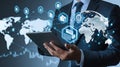 Businessman managing global data network and digital files with a tablet, interconnected world map background. Royalty Free Stock Photo
