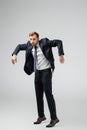 Businessman marionette in suit posing with