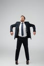 Businessman marionette in suit posing with