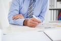 Businessman marking the newspaper with marker