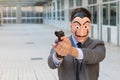 Businessman with mask holding a gun