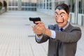 Businessman with mask holding a gun