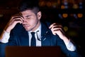 Businessman Massaging Nosebridge Holding Eyeglasses Sitting In Office At Night Royalty Free Stock Photo