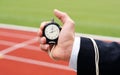 Businessman measures elapsed time with stop watch Royalty Free Stock Photo
