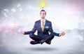 Businessman meditates with enlightenment concept Royalty Free Stock Photo