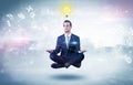 Businessman meditates with enlightenment concept Royalty Free Stock Photo